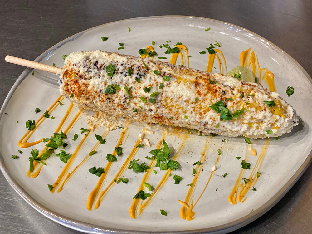 Mexican street corn dusted with cheese and chile